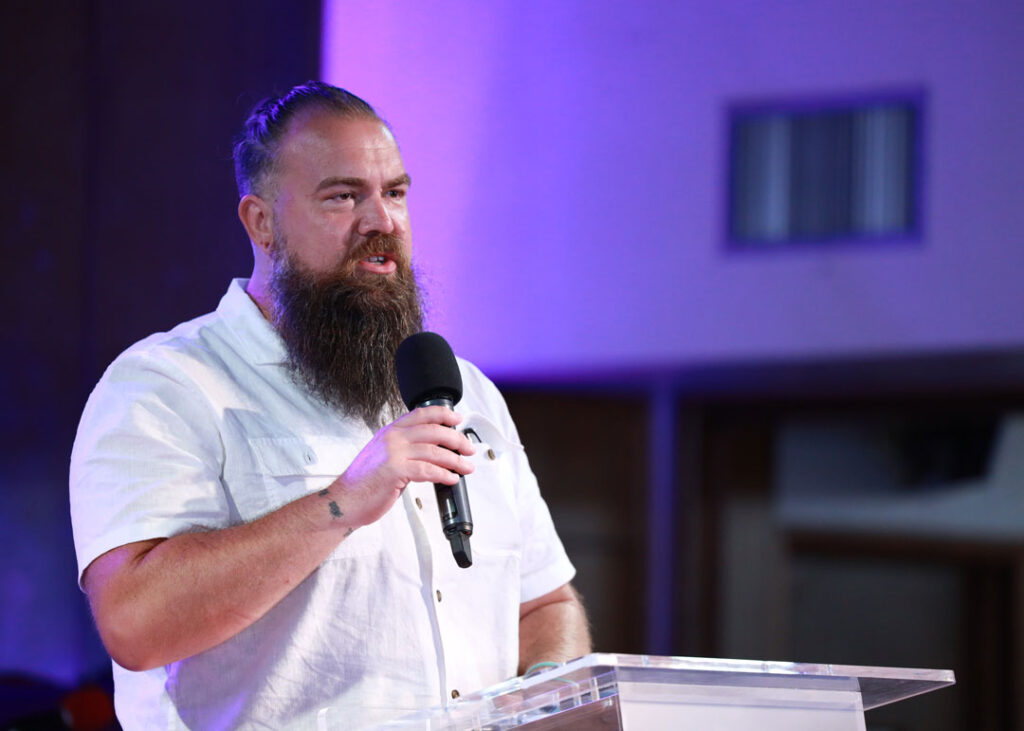 Man speaking at pulpit.